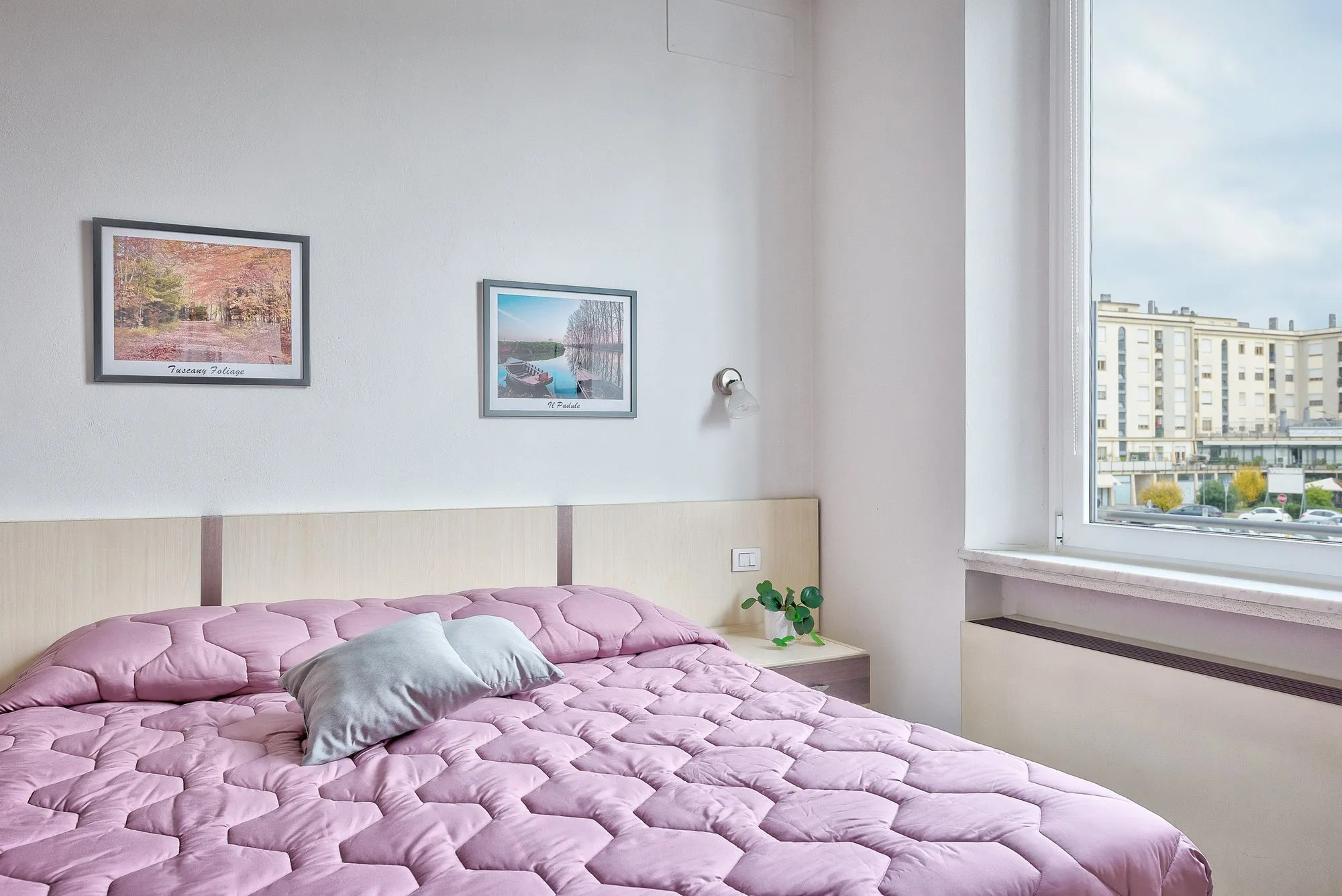 Letto matrimoniale con quadri alla parete
